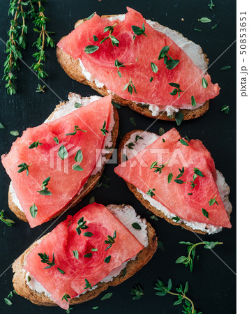 Toasts with watermelon, soft cheese and thyme Toasts with watermelon, soft cheese and thyme 50853651