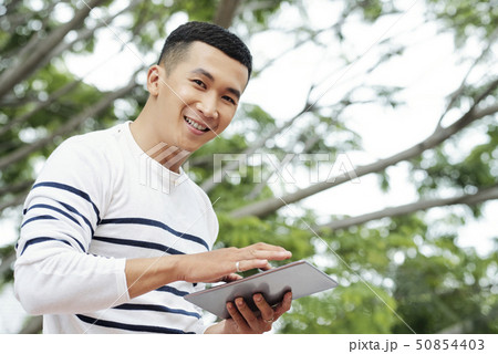 Young man working on tablet 50854403