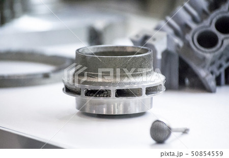 Man is holding object printed on metal 3d printer Man is holding object printed on metal 3d printer 50854559