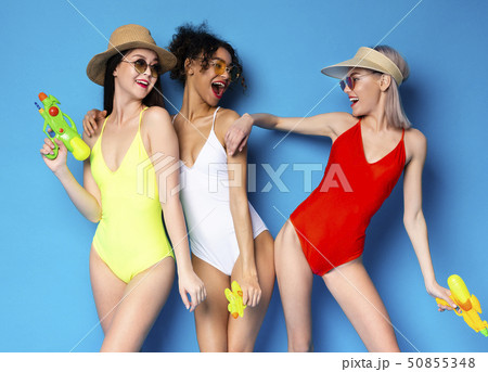 Happy Multiethnic Girls In Swimsuits Having Fun With Water Guns 50855348