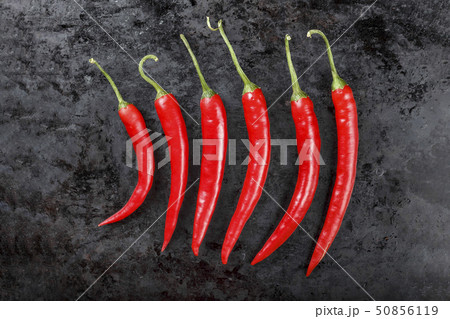 red peppers laid out in a row 50856119