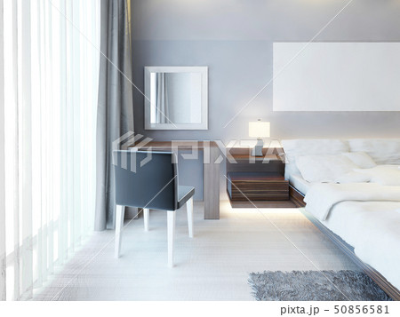 Neat dressing table with a mirror in a white frame 50856581
