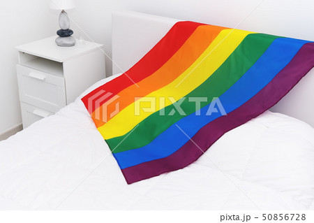 Top view of rainbow flag LGBT community on white bed in bedroom 50856728