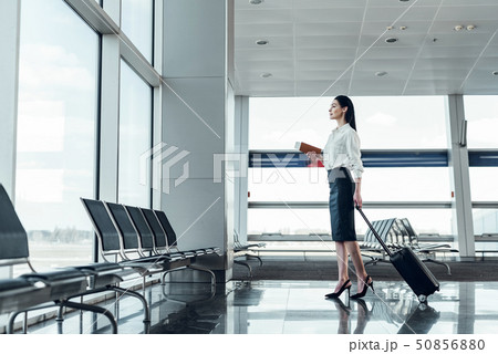 Excited young woman is travelling by air Excited young woman is travelling by air 50856880