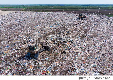 two bulldozer working on mountain of garbage in landfill two bulldozer working on mountain of garbage in landfill 50857382