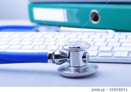 books folder file, stethoscope and laptop, keyboard isolated on white background. 50858051