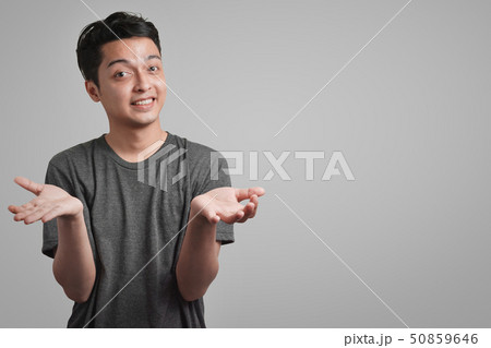 man wear gray t-shirt looking at camera 50859646