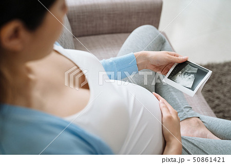 pregnant belly and x ray ultrasound scan of baby 50861421