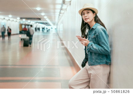 joyful girlfriend leaning on wall waiting 50861826