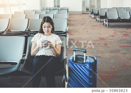 Tourist Women using Phone at international airport 50863623