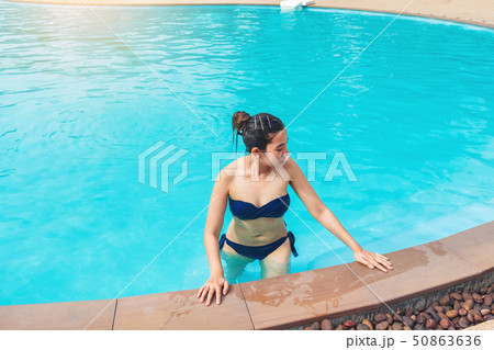 Carefree woman relaxation in swimming pool summer 50863636