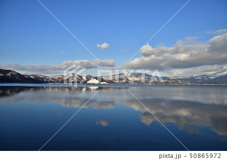 秋田県 冬の田沢湖リフレクションの写真素材