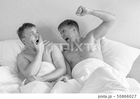 Handsome gay men couple on bed together. Love and Handsome gay men couple on bed together. Love and 50866027