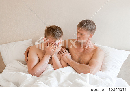 Handsome gay men couple on bed together. Love and Handsome gay men couple on bed together. Love and 50866051