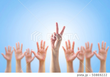 Leader two fingers victory sign among blur hands Leader two fingers victory sign among blur hands 50869222