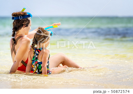 Young mother and little daughter enjoying the beach in Dominican Republic Young mother and little daughter enjoying the beach in Dominican Republic 50872574