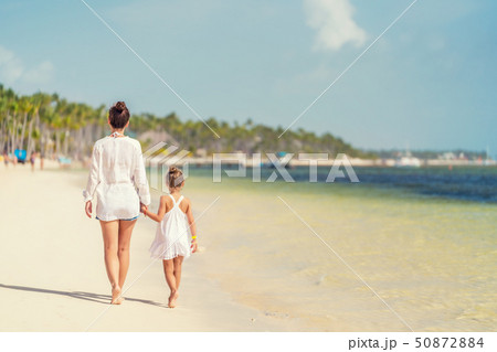 Young mother and little daughter enjoying the beach in Dominican Republic Young mother and little daughter enjoying the beach in Dominican Republic 50872884