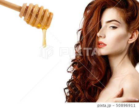 Woman with honey spoon prepare for hair mask. 50896911