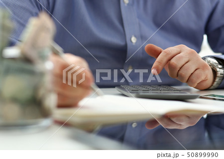 Male hand using calculator counting financial expenses 50899990