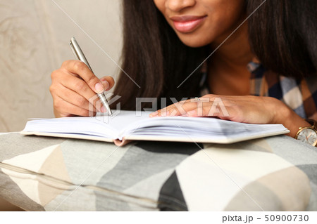 Arm of black woman write story in notebook 50900730