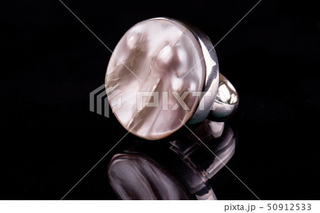 A silver ring with pink pearls under nacre in a  50912533
