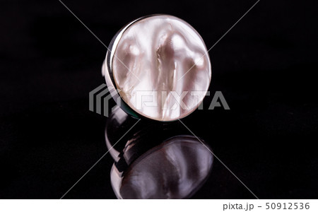 A ring with a pearl with three flows of nacre with 50912536
