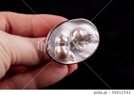 A silver ring with three pearls under a nacre  50912543