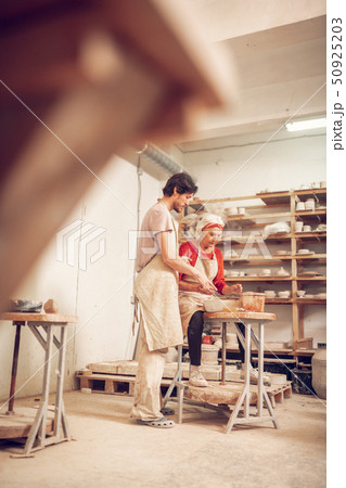 Nice skilled people standing together near the wheel Nice skilled people standing together near the wheel 50925203