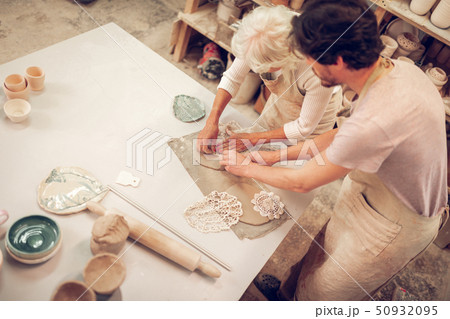 Top view of two artists using crocheted napkins 50932095