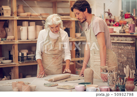 Nice skilled artists standing together at the table 50932798