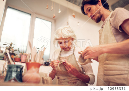 Low angle of a pleasant serious woman working Low angle of a pleasant serious woman working 50933331
