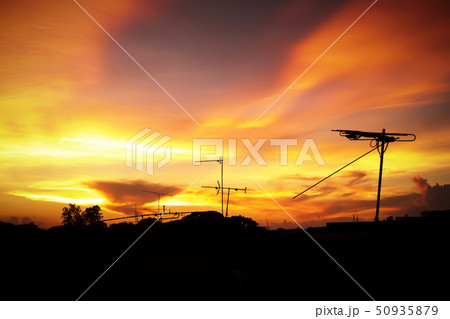 Silhouette of sunset with television antenna 50935879