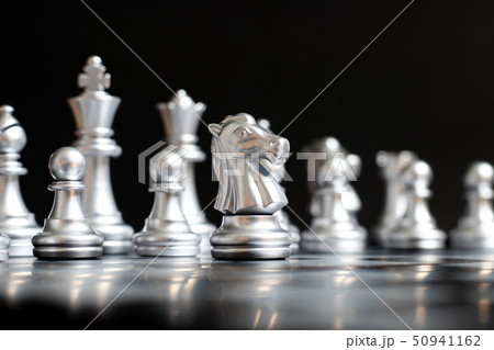 Silver knight chess piece stand in front of team 50941162