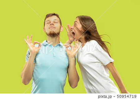 Beautiful couple isolated on green studio background 50954719