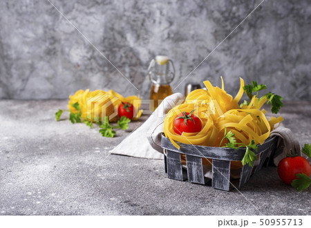 Raw pasta tagliatelle or fettuccine 50955713