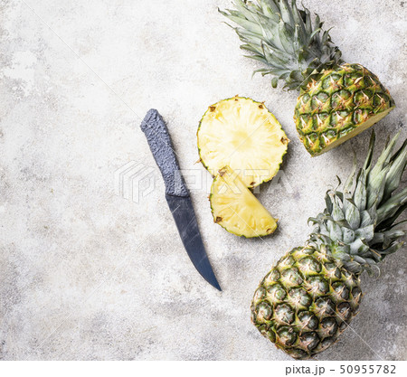 Sliced pineapple on white table Sliced pineapple on white table 50955782