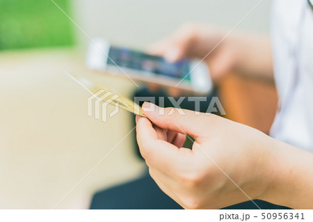 people typing credit card number in smartphone app 50956341