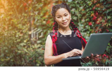 Beautiful Asian Business Woman Posing with Laptop Outdoor Beautiful Asian Business Woman Posing with Laptop Outdoor 50956419