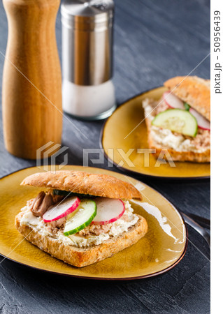 Delicious tuna sandwich, served with radish and Delicious tuna sandwich, served with radish and 50956439