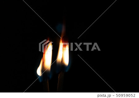 Two burning matches in the dark close up 50959052