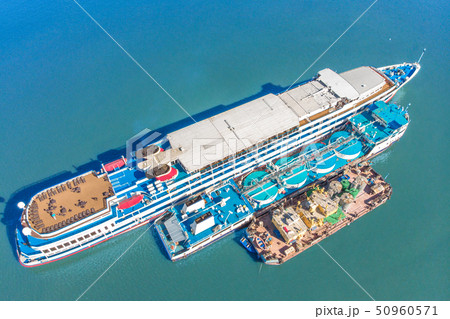 Refueling at sea - Small Oil products ship fuelling a large Bulk carrier, aerial image. 50960571