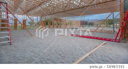 Wooden beams and red ladders in yard pano 50963391