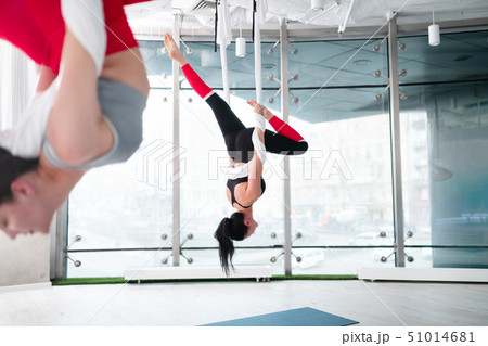 Two women wearing comfy leggings doing aerial yoga together 51014681