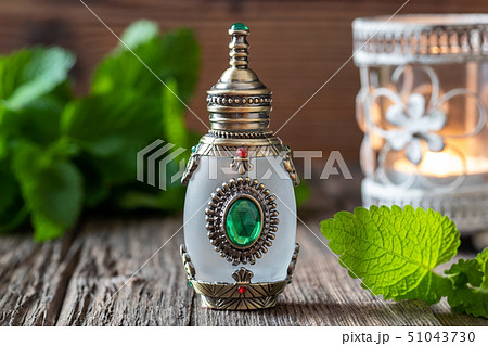 A bottle of melissa essential oil with melissa 51043730