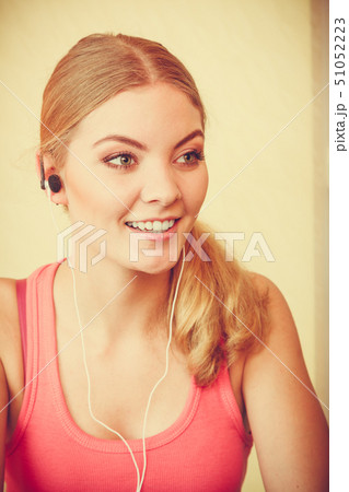 Woman with earphones listening to music. Leisure. Woman with earphones listening to music. Leisure. 51052223