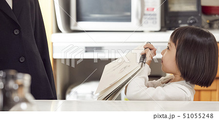 キッチンで母にスケッチブックを見せる娘 51055248