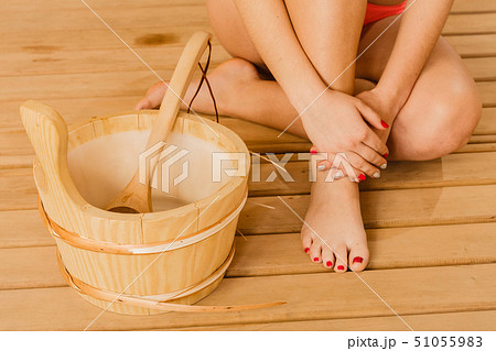 Closeup human woman legs feet and sauna bucket. Closeup human woman legs feet and sauna bucket. 51055983