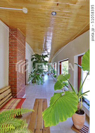 Hall with a wooden ceiling and tiled floor and a h 51058395