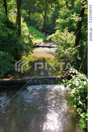 A fast river flowing with large water currents aga 51059035