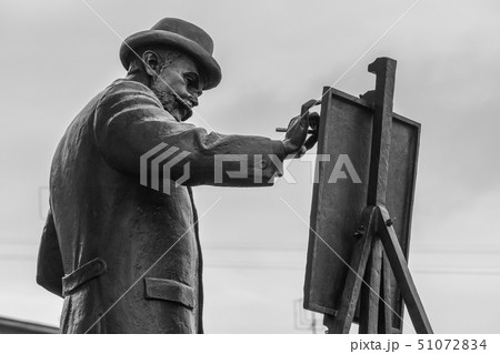 close-up of a monument depicting the artist drawin 51072834